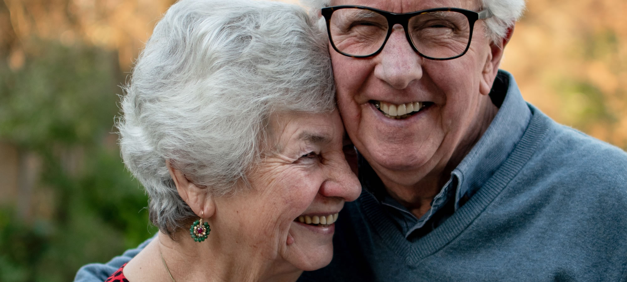 older couple hugging smiling